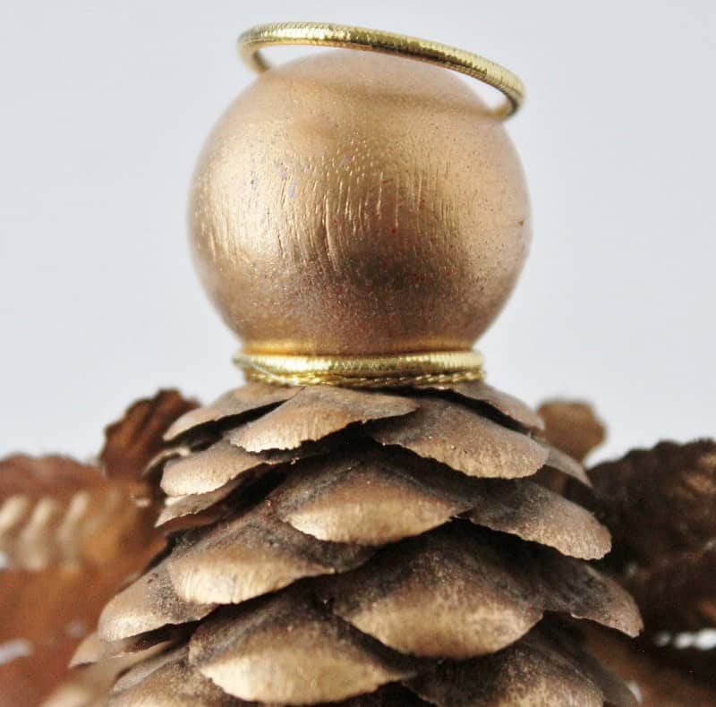 Showing gold cord tied around the angel's neck