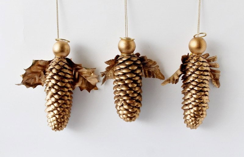 three large gold pine cone Christmas ornaments