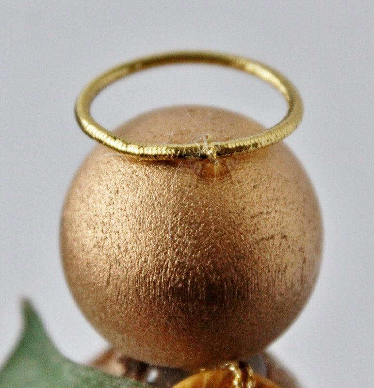 Halo attached to back of angel's head