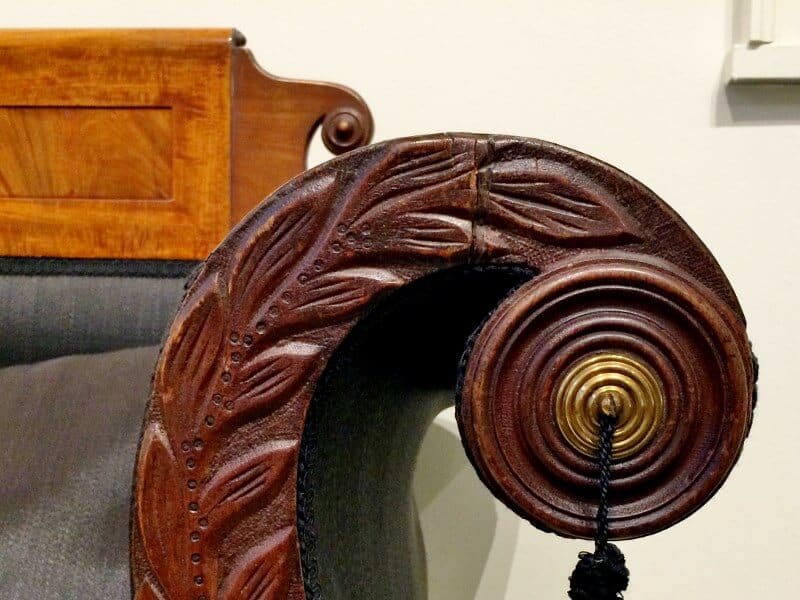 Curved arm rest on an gilded age couch