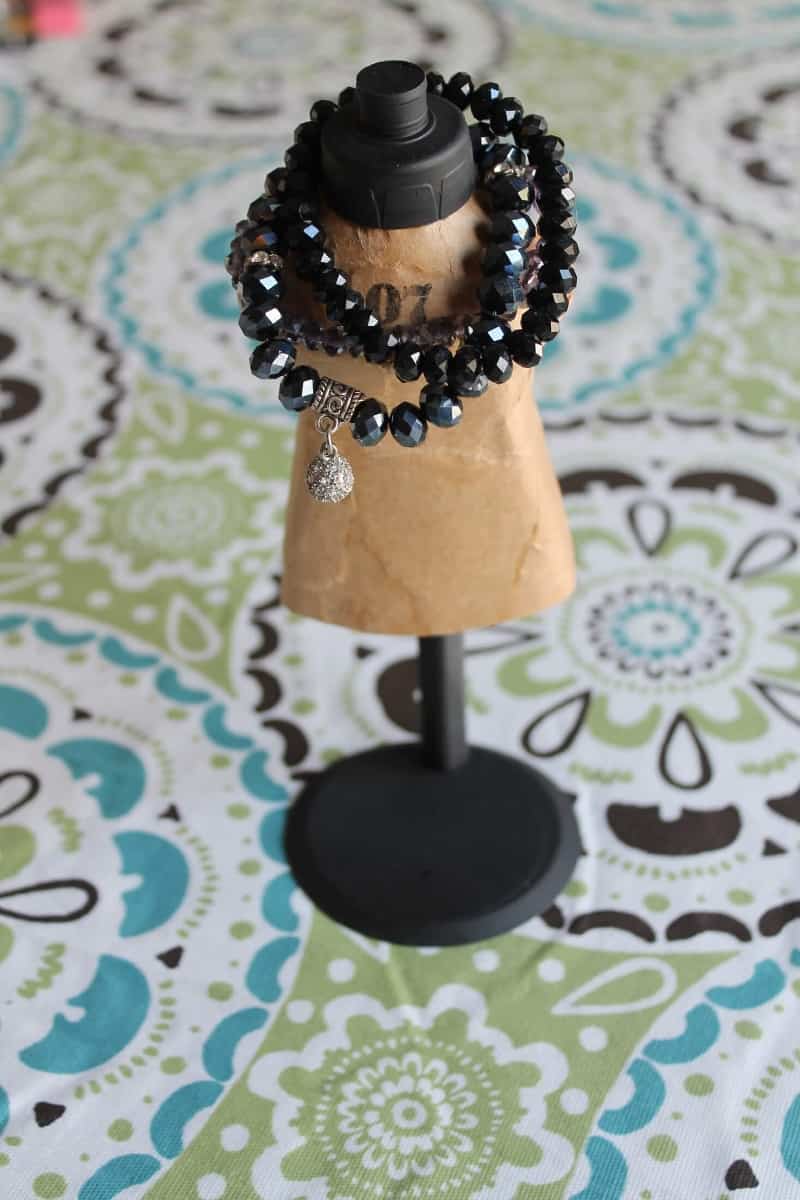 vintage style mini mannequin holding bracelets