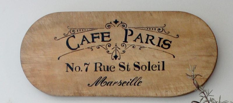 cafe paris sign on bread board