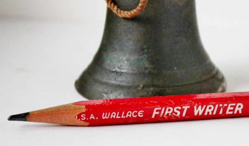 antique bell iwth vintage pencil