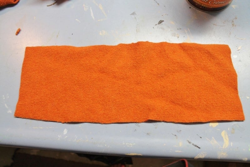 Piece of thrifted sweater for pumpkin candy container