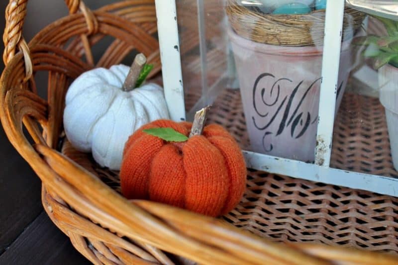 2 sweater pumpkins in wicker tray