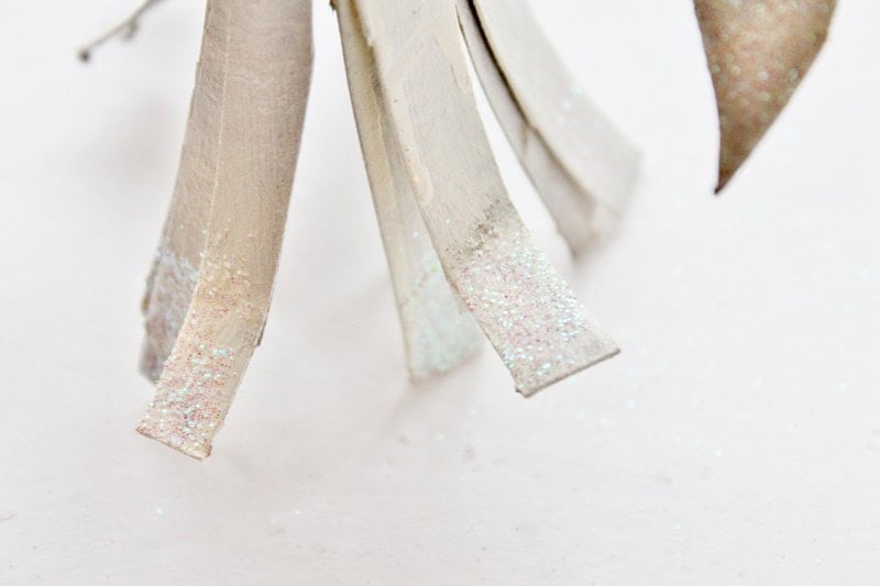 Glitter on bottom of toilte paper tube angel Glitter on the bottom of the angel's skirt