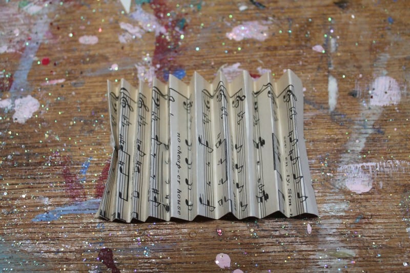 Folding vintage music paper like a fan