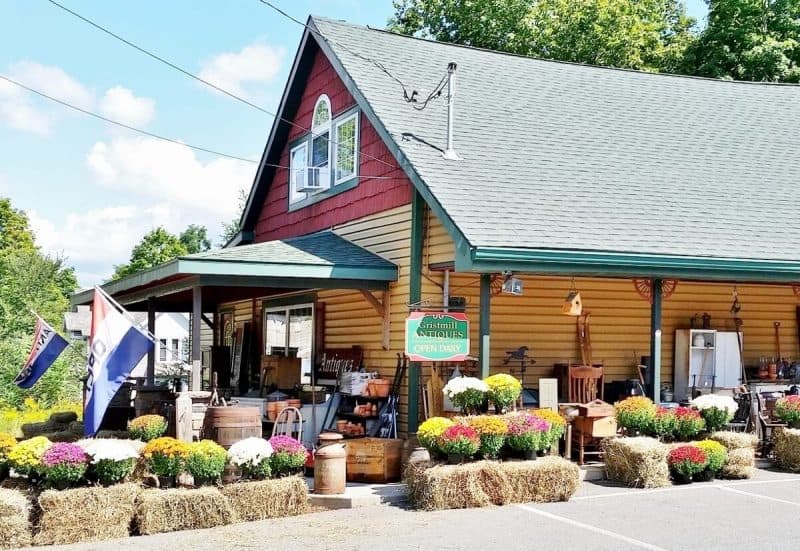 Gristmill Antique Center decorated for fall with hay bales and mums