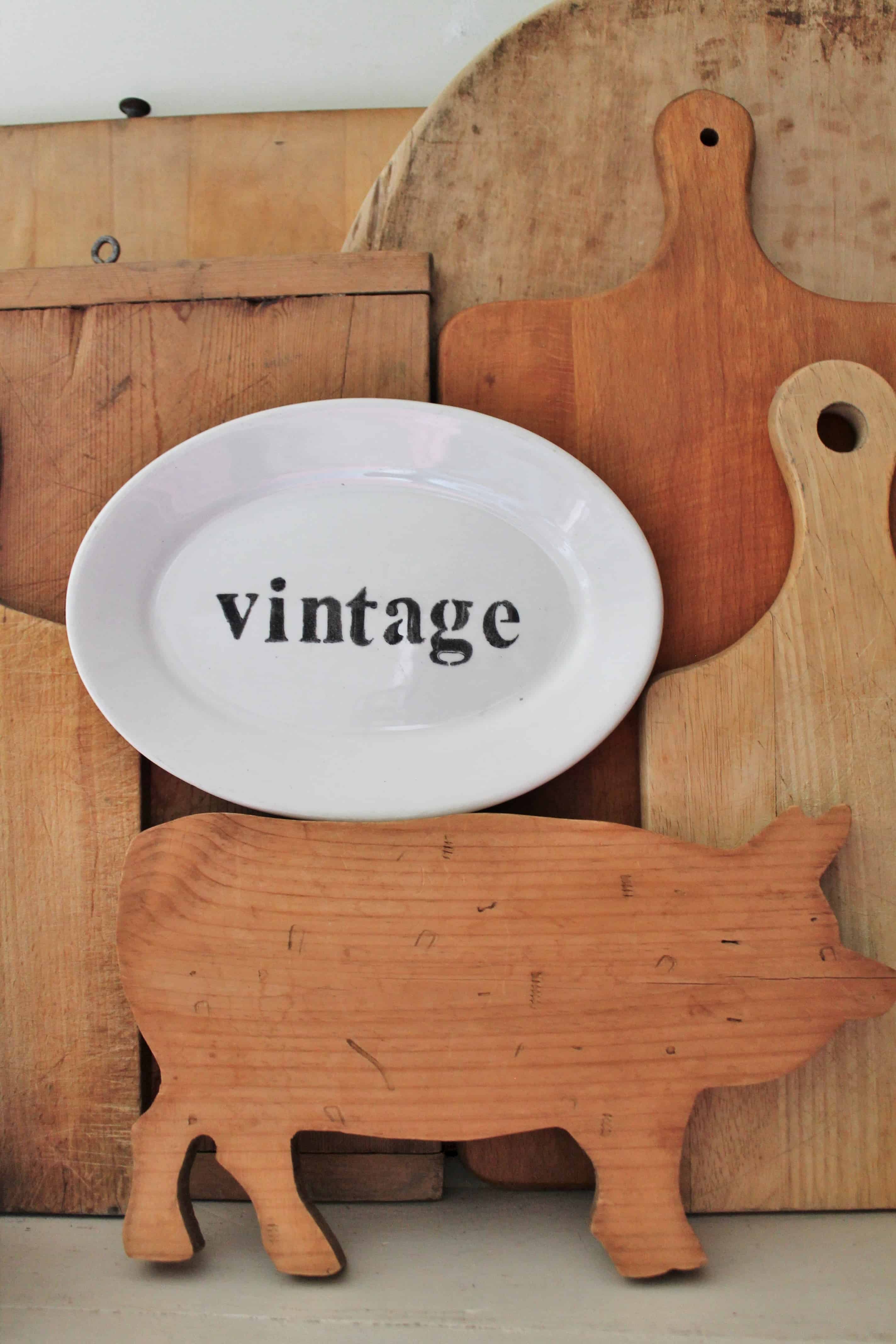 Vintage platter sign staged with breadboards