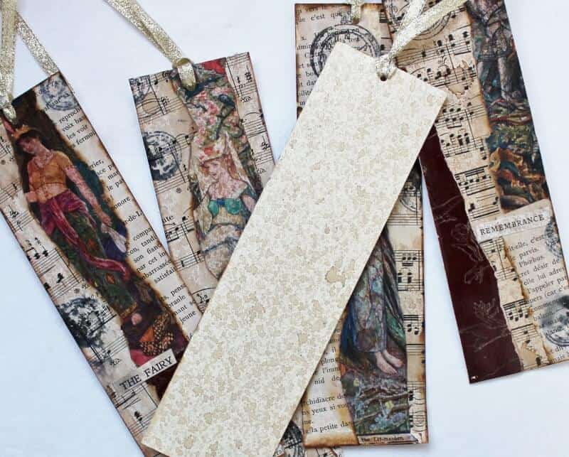 several altered art bookmarks with one showing the back aged