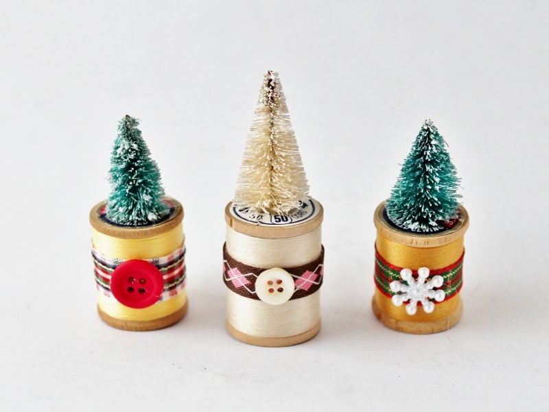 yellow, ivory, and gold spools of thread with bb trees on top