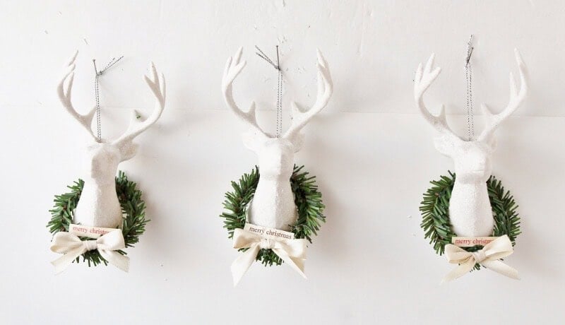 white deer heads decorated with mini wreaths
