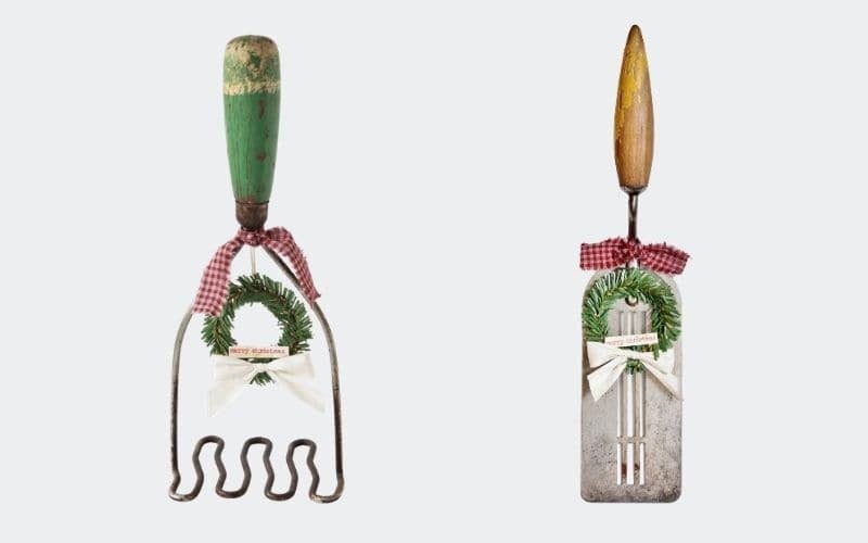 a potato masher and spatula with mini wreaths attached
