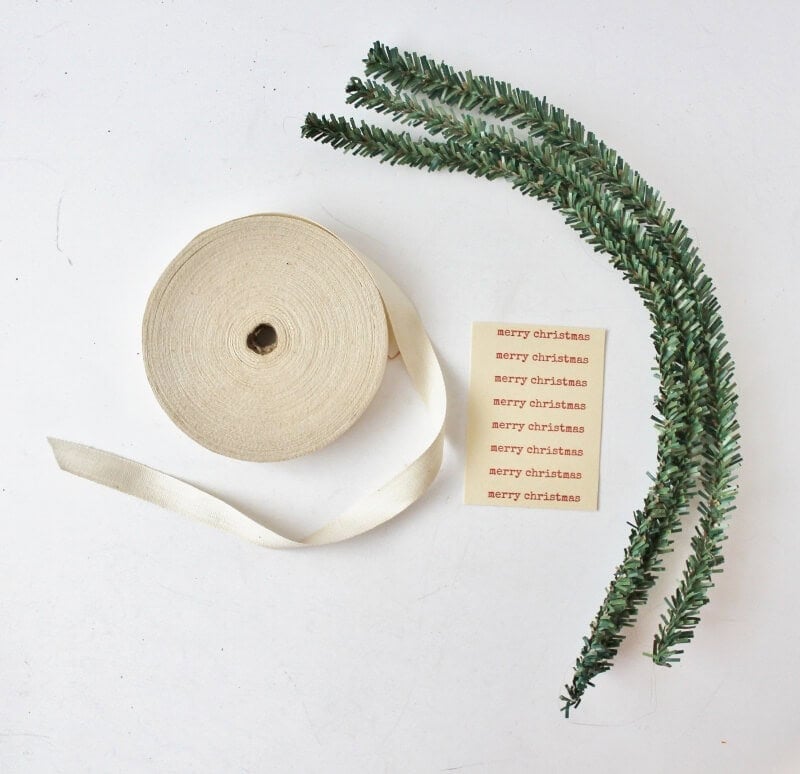 Materials to make mini wreaths: ribbon, tags, pipe cleaners