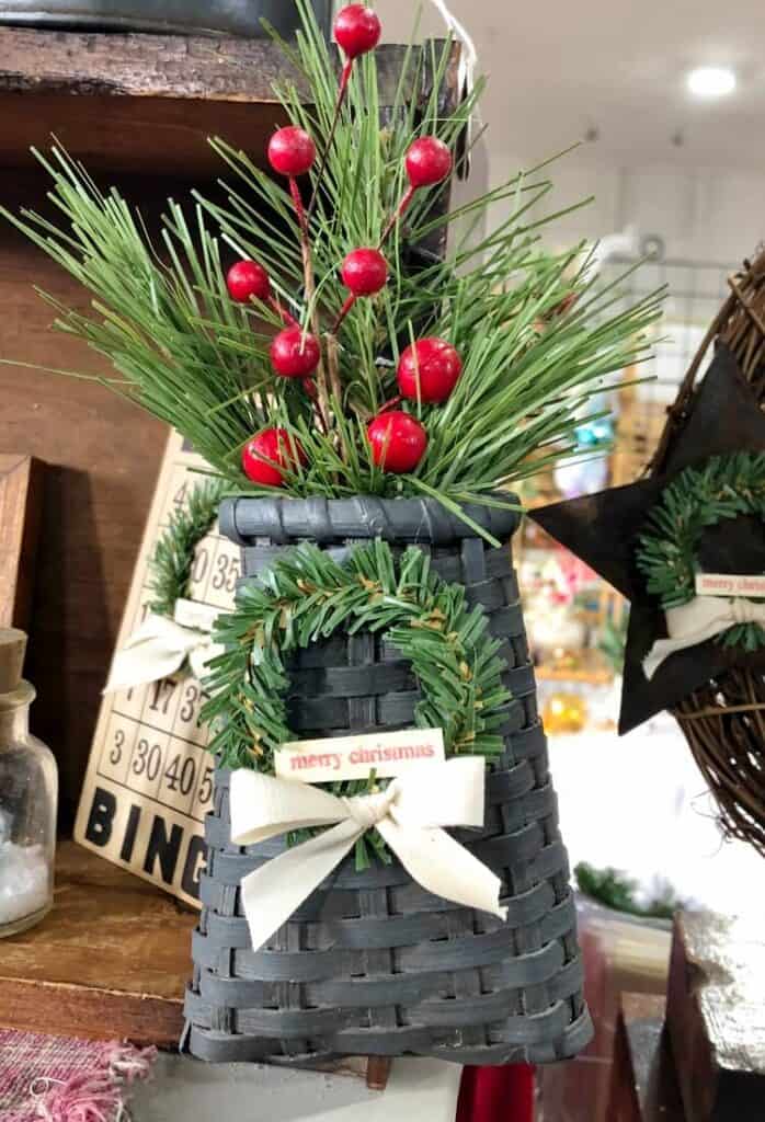mini wreath on a blue basket with greens and berries
