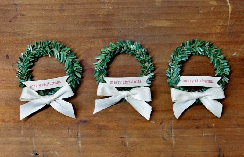 3 mini wreaths on wood background