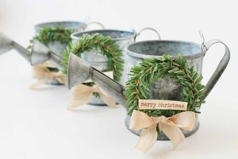 mini watering cans decorated with mini wreaths