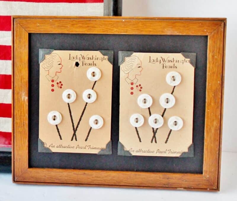 Antique buttons in oak frame