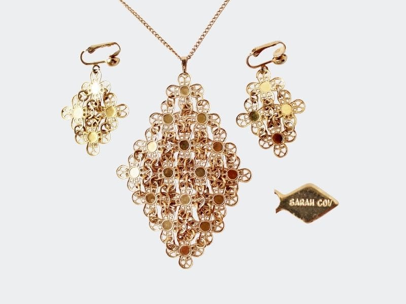 Gold diamond-shaped pendant necklace and matching earrings