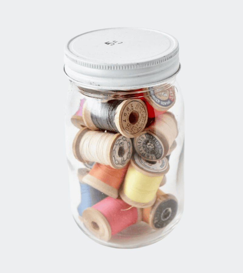 Jar with spools of thread
