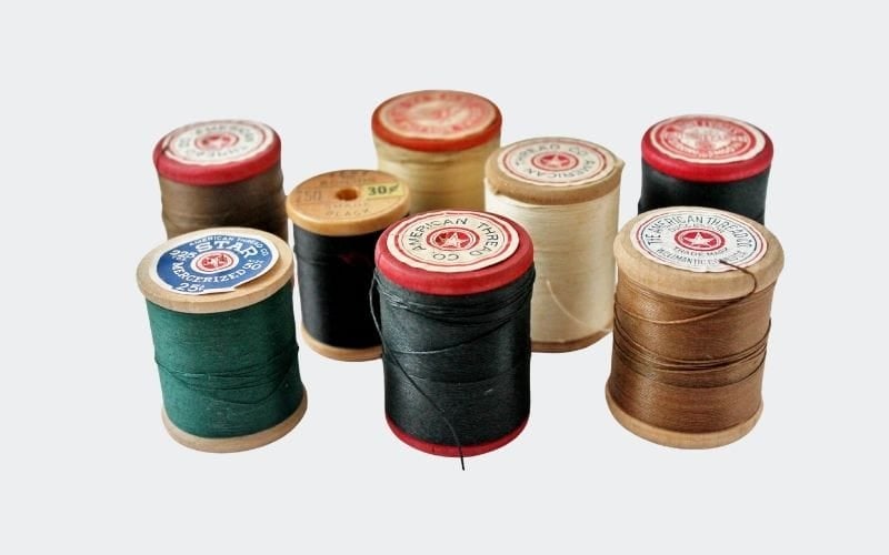 Collection of spools of thread with red stars on top