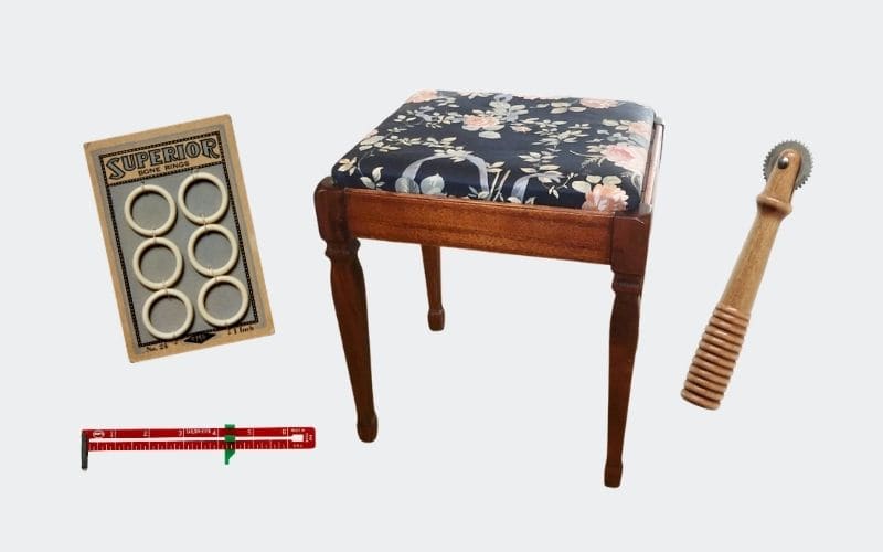 4 vintage sewing related items: rings, measuring tool, sewing stool, and pattern tracer