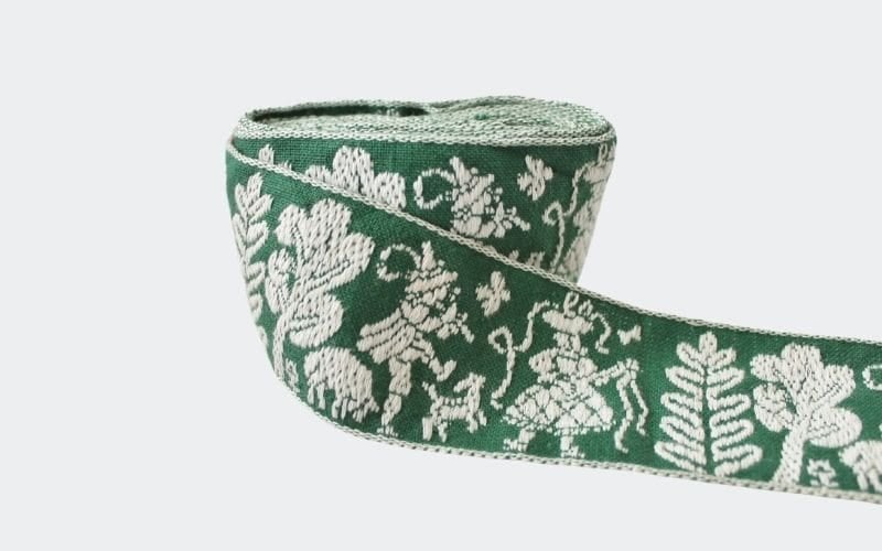 wide green trim with white figures and trees