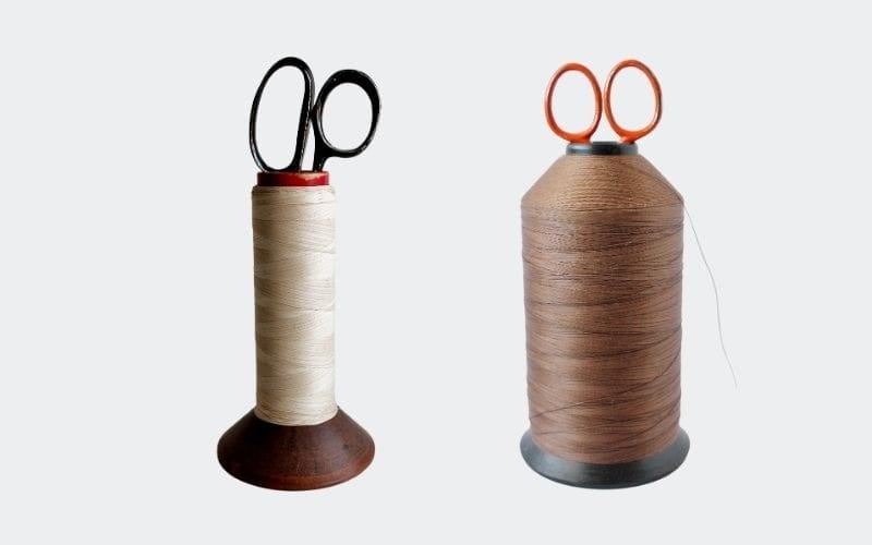 two spools of thread with scissors down the center