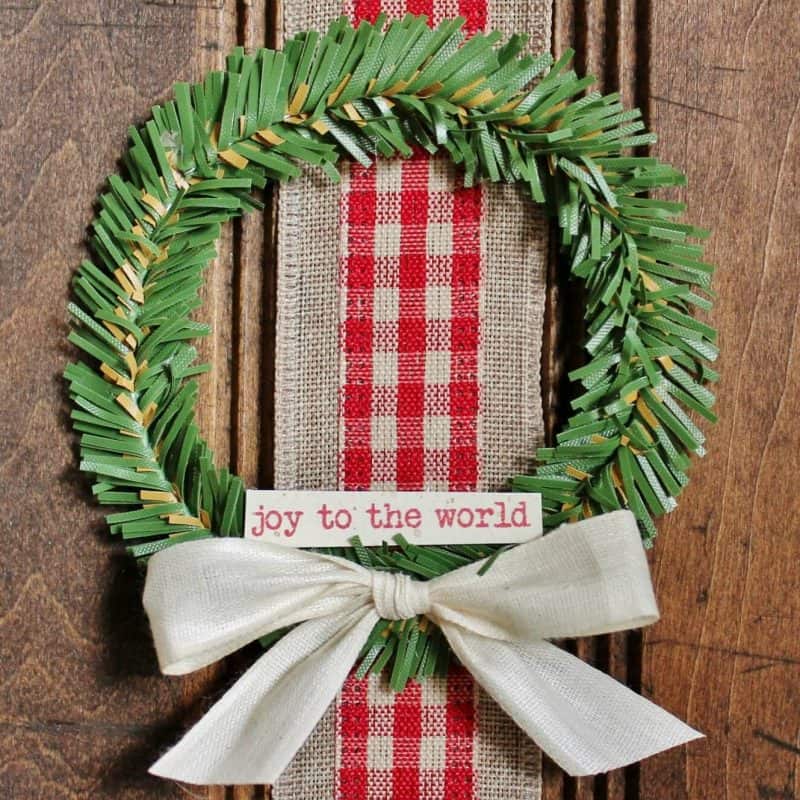 close up of mini christmas wreath on fish scaling board