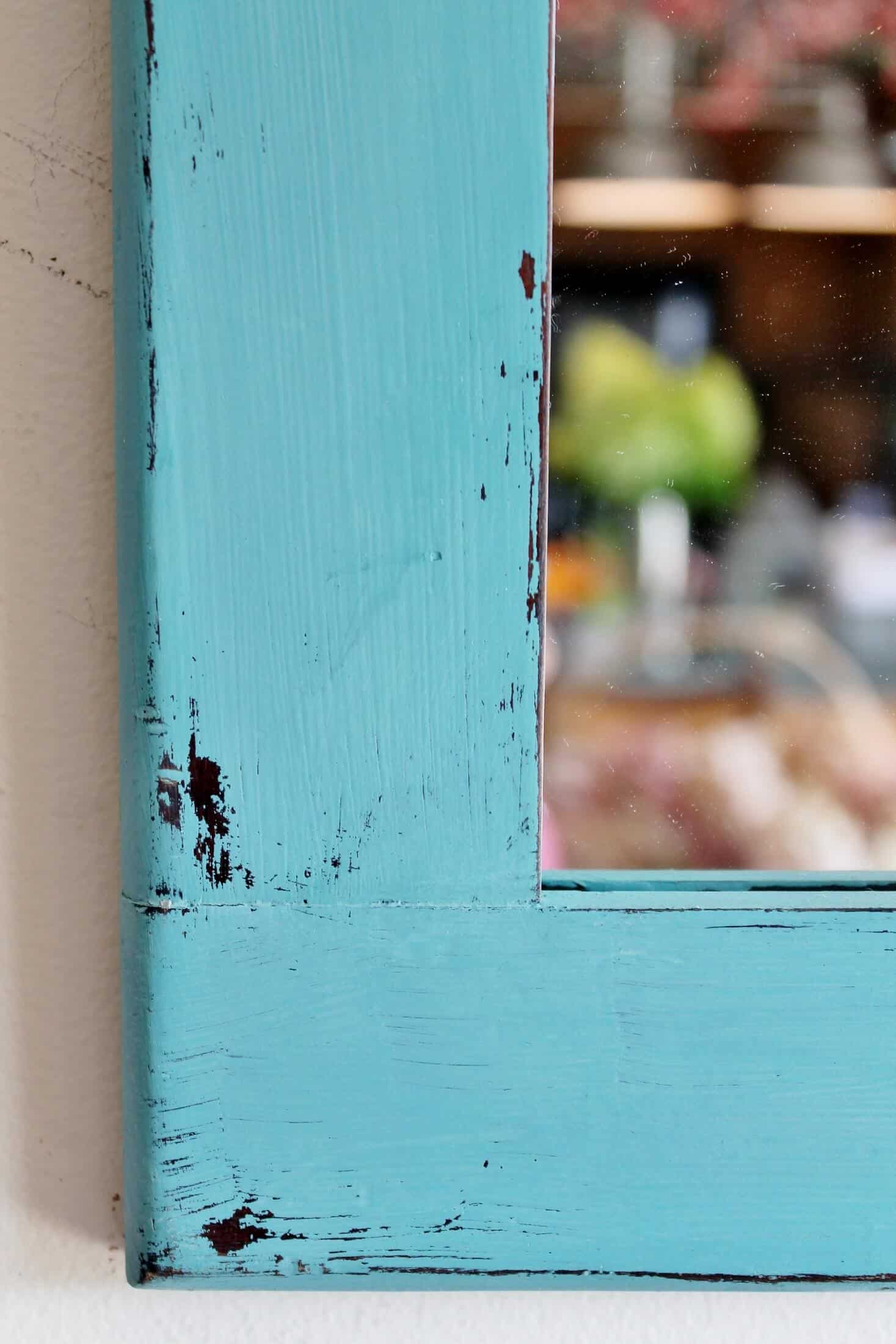 close up of aqua blue chalk paint on vintage mirror refresh