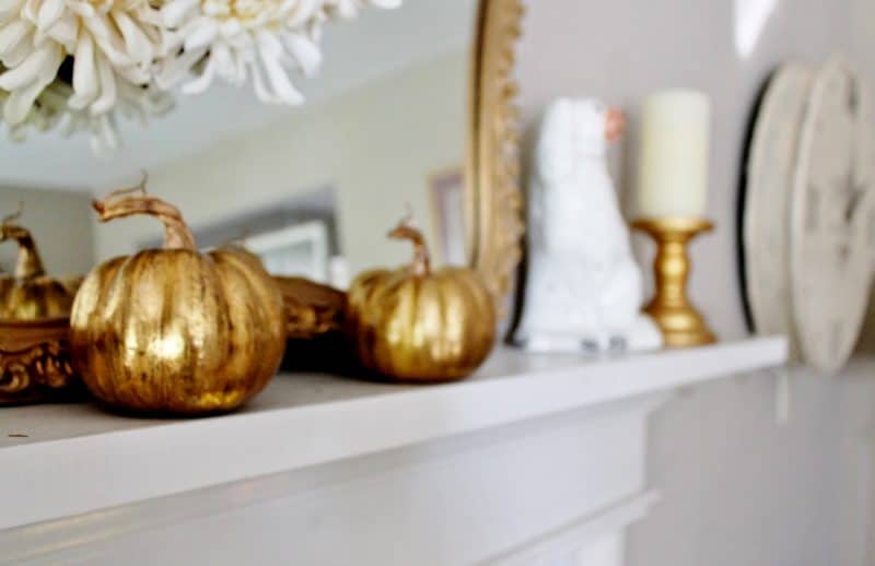 fall mantel with gold pumpkins and staffordshire dogs