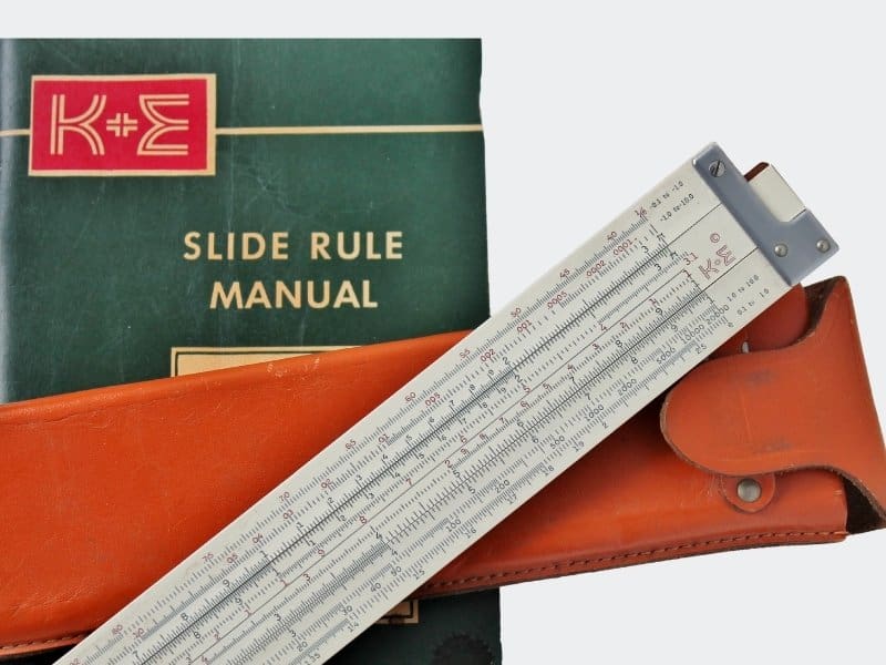 white slide rool with orange case and booklet