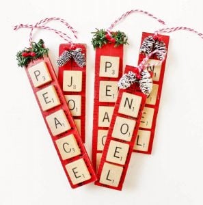 red yardstick and scrabble tile christmas ornaments that spell words like "peace" and "noel"