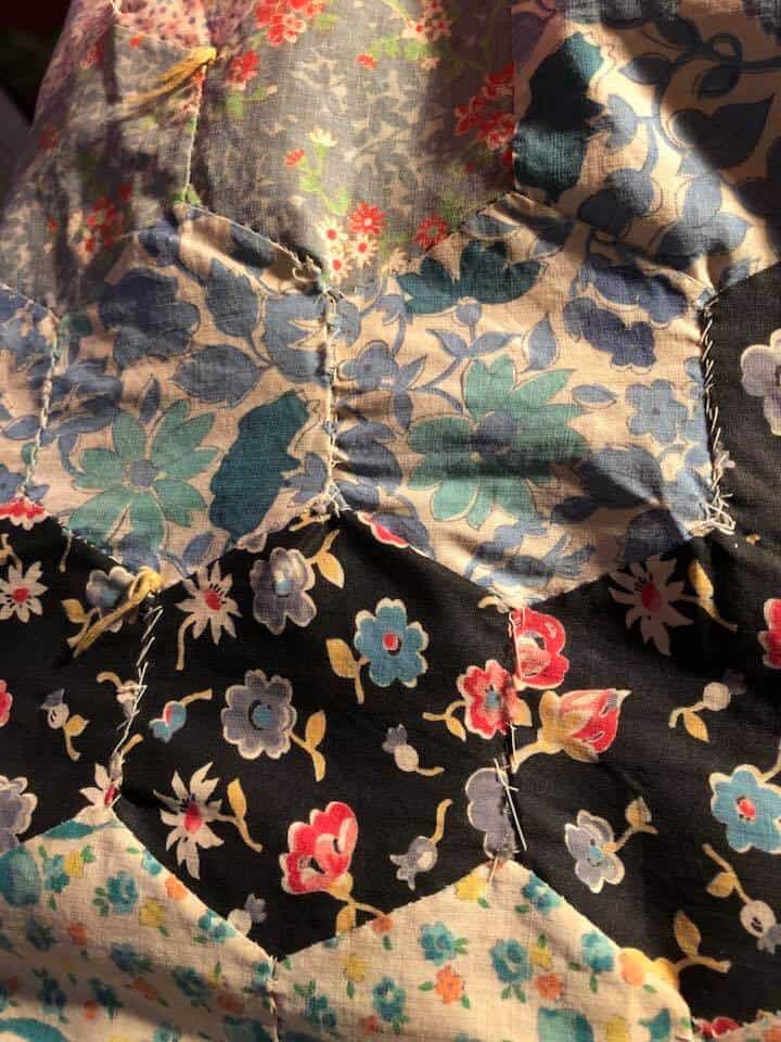 close up of worn and repair vintage quilt