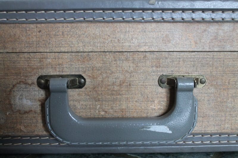 sticky price tag on suitcase handle