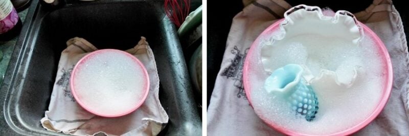 bowl of sudsy water next to bowl with glassware in it