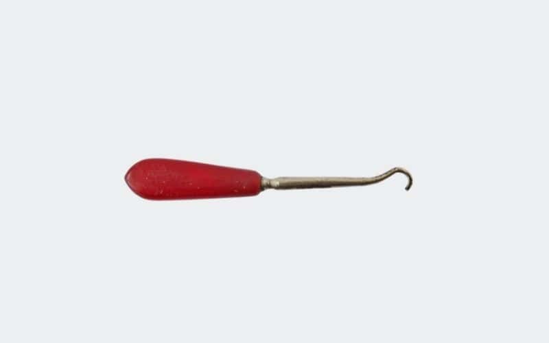 small, red handled button hook