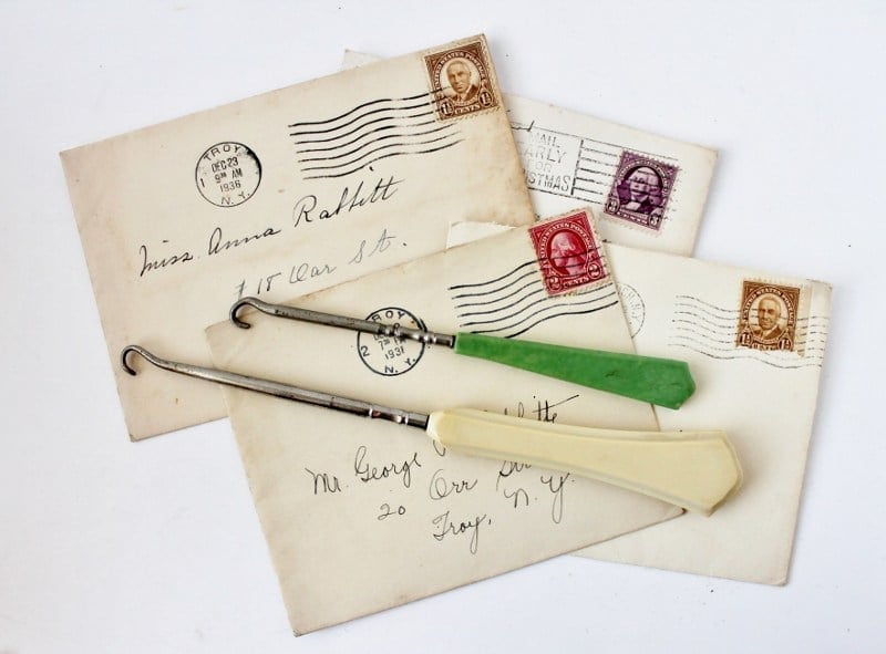 2 button hooks on antique letters, one bakelite, the other celluloid