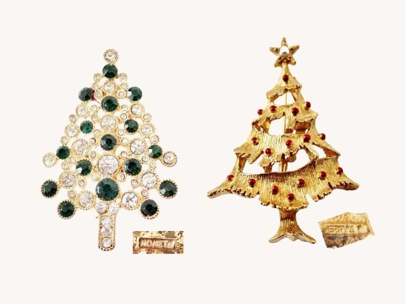 two Christmas tree pins--one with green and clear rhinestones, the other gold with colorful enamel ornaments