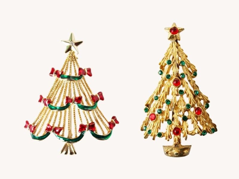 Two vintage christmas tree pins both gold, one with bows, the other with colorful rhinestones