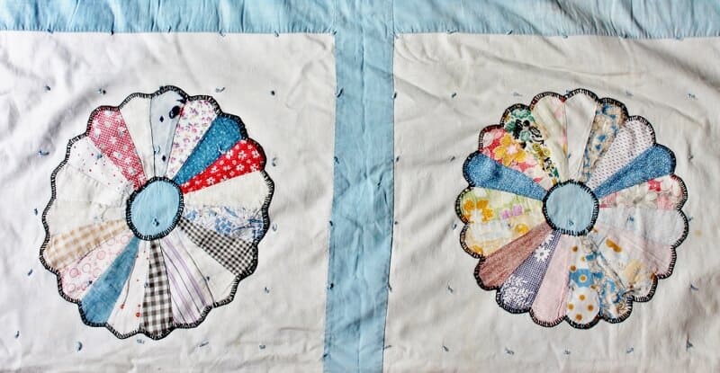 vintage "dresden plate" quilt with colorful fabric on white background