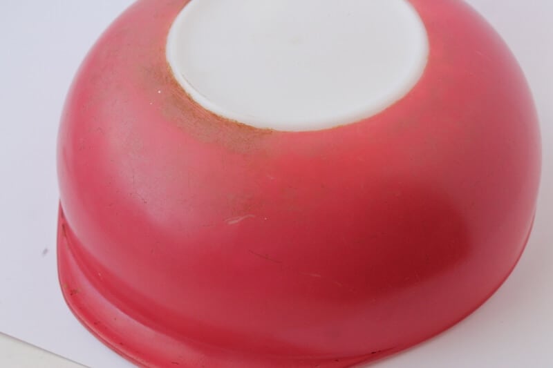 bottom of dirty flamingo pyrex casserole before cleaning