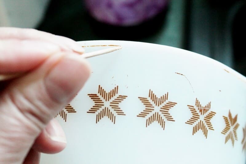 Using a toothpick to remove grime from vintage Pyrex