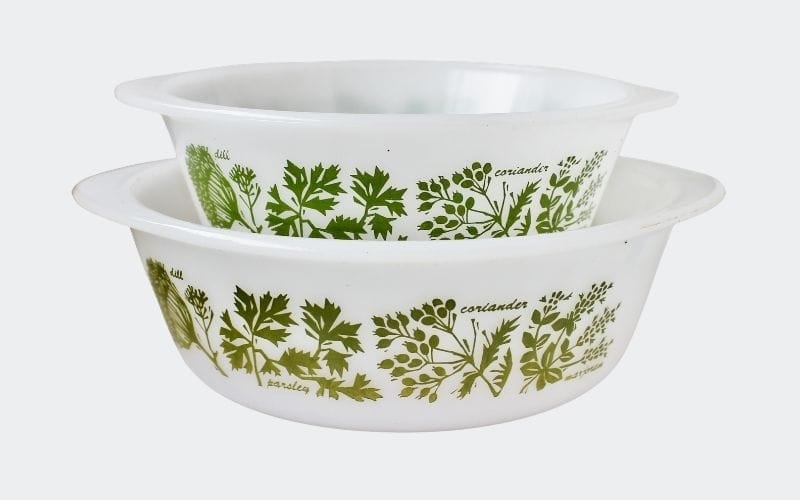 white glass casseroles with green herbal decorations