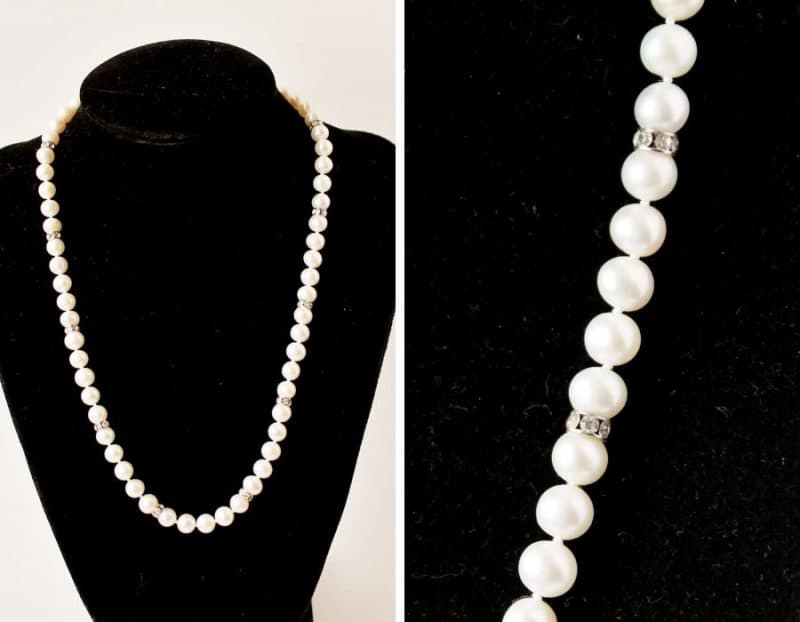 Pearl necklace on black display with a closeup