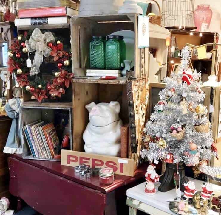 Lots of small antiques in crates atop a table