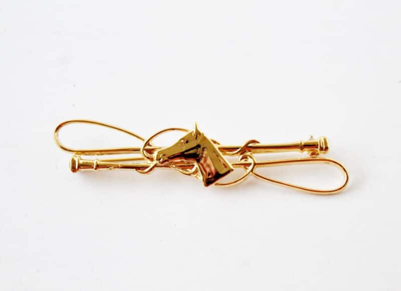 Gold tone horse head bar pin