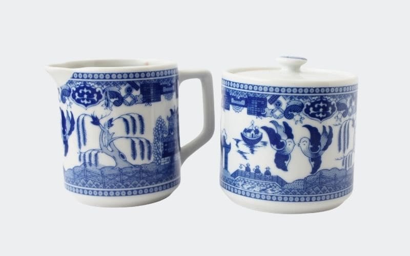 set of glue and white china creamer and sugar