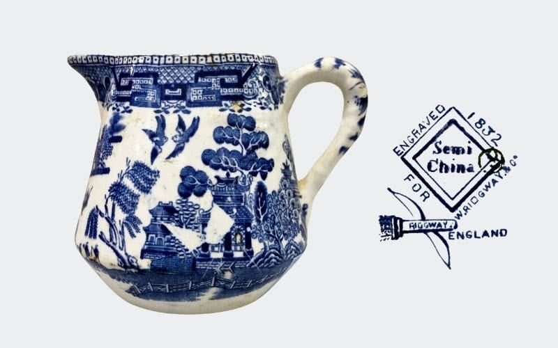 small creamer with blue decoration on white background