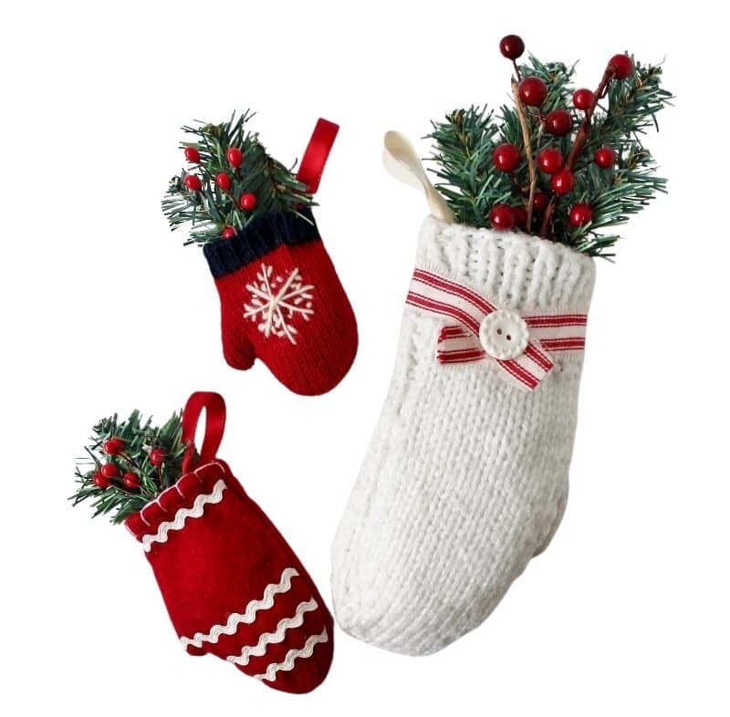 1 white mitten and 2 red ones with greens and berries